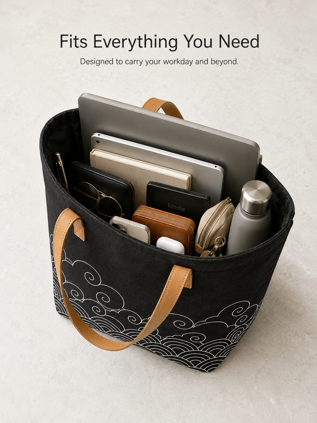 Kumo tote bag interior fitting a laptop, notebook, kindle, wallet, and water bottle