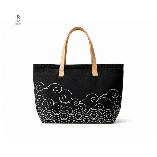 Kumo black canvas tote bag with Japanese wave print and tan leather handles - front view