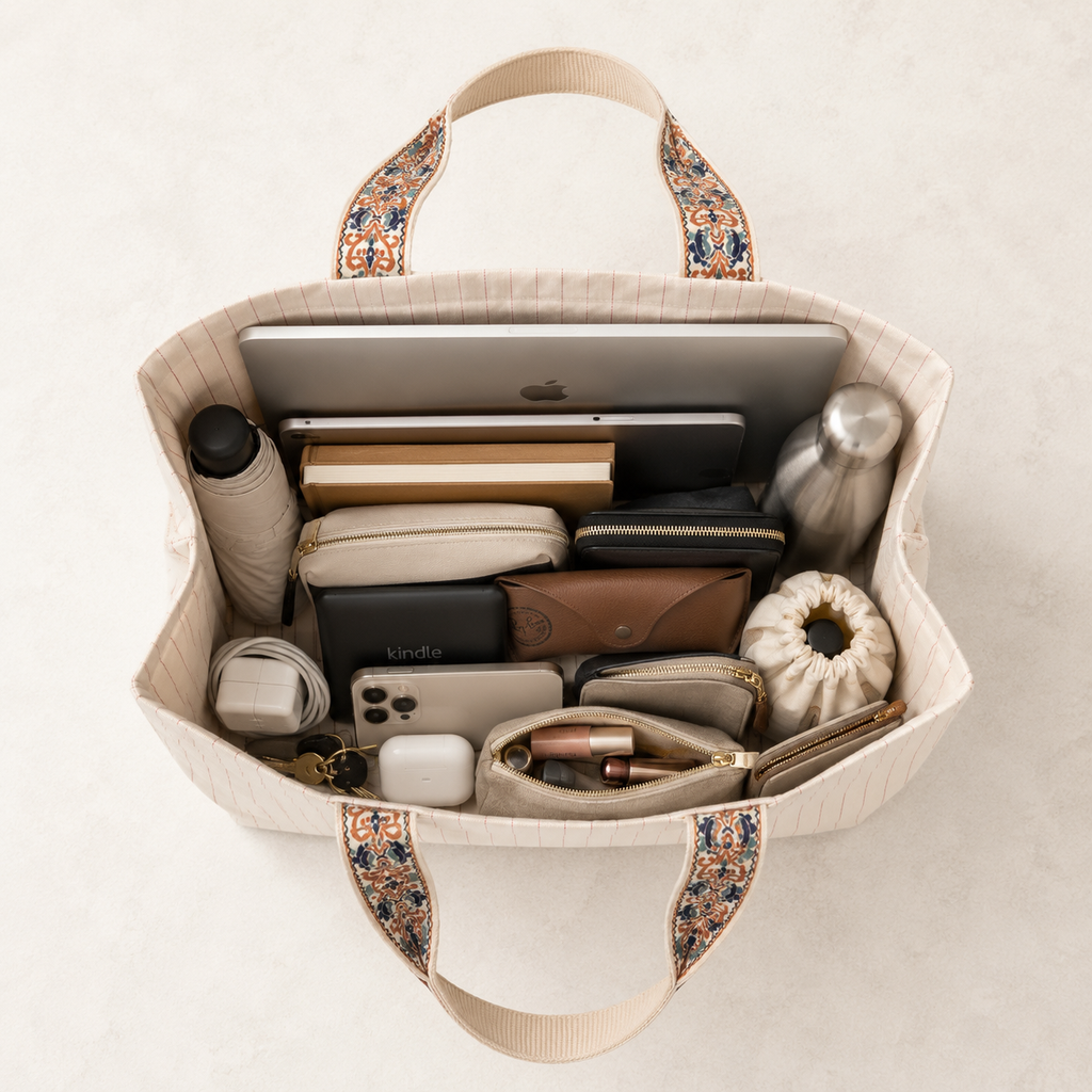 What fits inside the Darbar tote bag - laptop, notebook, makeup bag flat lay