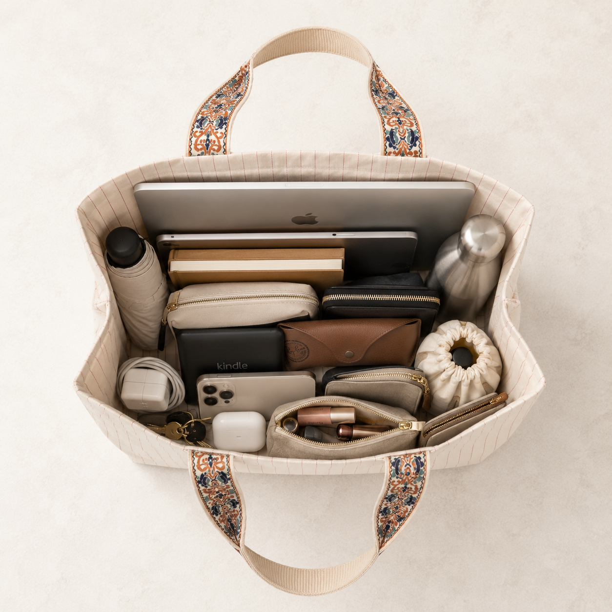 What fits inside the Darbar tote bag - laptop, notebook, makeup bag flat lay